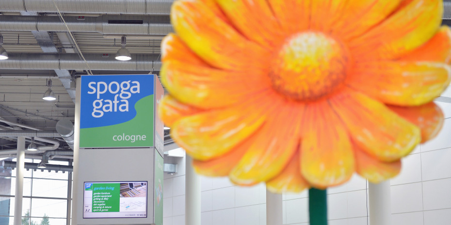 Large artificial flowers advertised living green on the exhibition grounds. 
